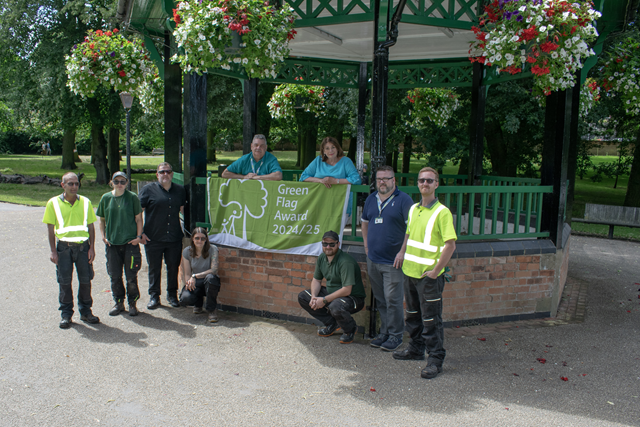 (centre, in bandstand) Cllr Neil Sandison, Rugby Borough Council's Liberal Democrat spokesperson for partnerships and wellbeing, and Cllr Maggie O'Rourke, Rugby Borough Council portfolio holder for partnerships and wellbeing, celebrate the Green Flag success in Caldecott Park with the council's (left to right) Christian Cooper (green spaces supervisor), Leah Anderson-Howe (gardener), John Howes (green space and biodiversity manager), Fern Seagermills (grounds maintenance team leader), Daniel Mallinson (green spaces supervisor), Gary Fearnley (civil contracts officer) and Thomas Malin (gardener).
