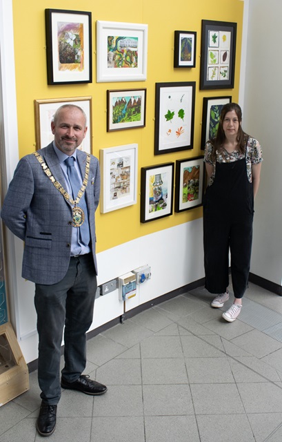 The Mayor of Rugby, Cllr Simon Ward, with artist Emma Barford at the display of artworks created by asylum seekers currently staying in the borough.