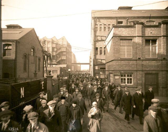 Done for the day - workers stream out of the gates at the end of a shift in March 1924.