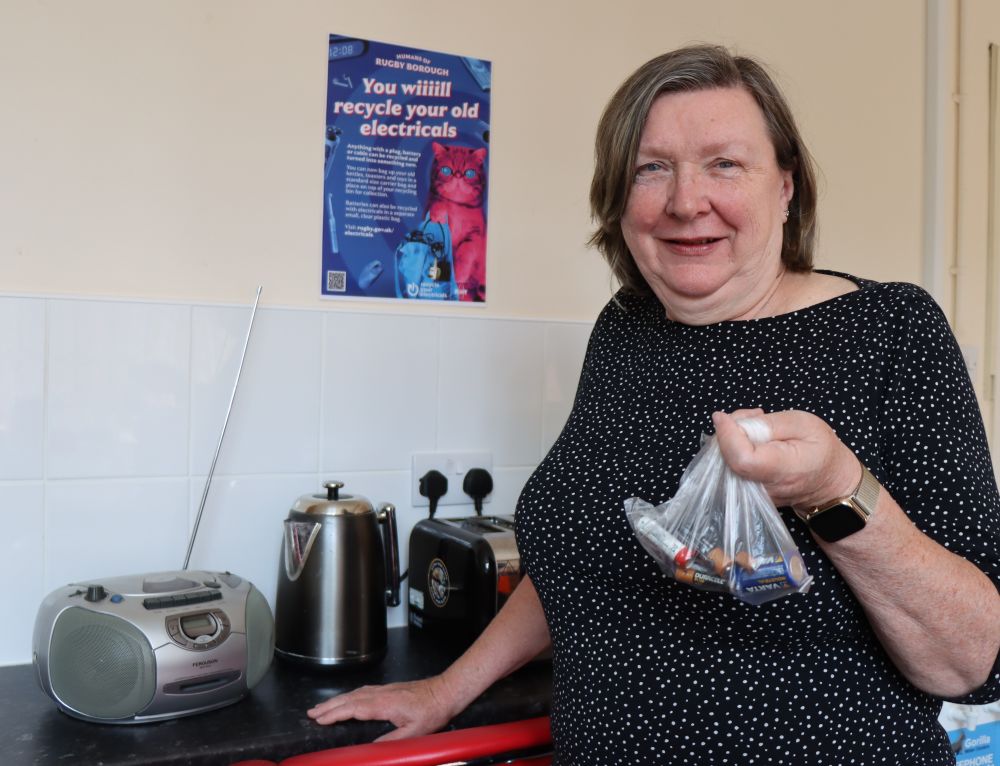 Cllr Alison Livesey demonstrates the types of small electricals and household batteries that can be collected.